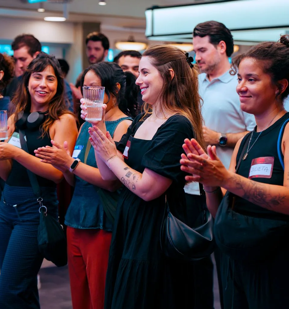 Attendees applauding after a talk.