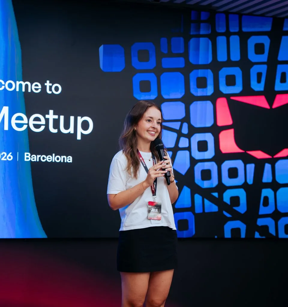 A host opening the evening in front of a large welcome screen.